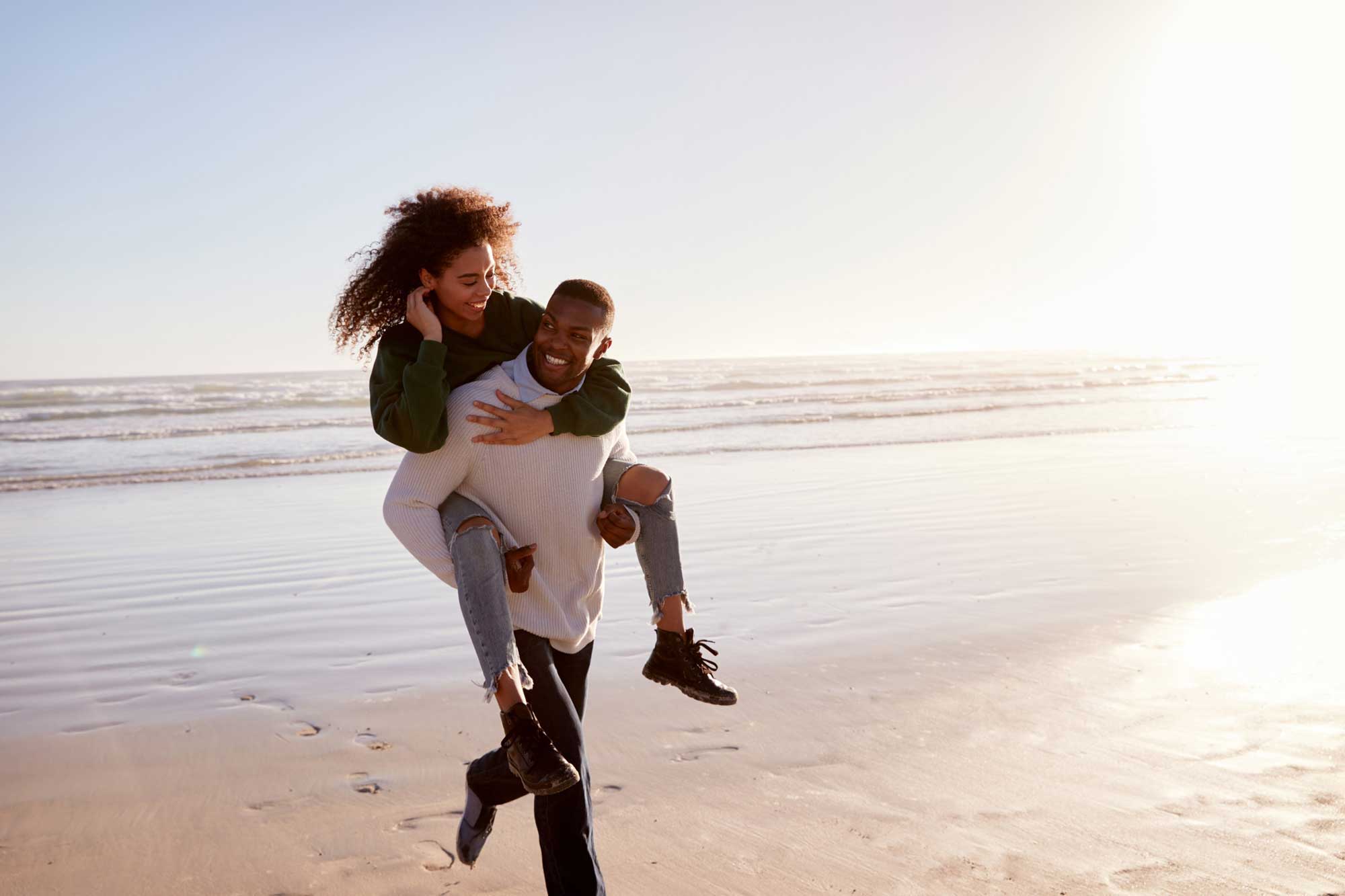 Man giving woman a piggyback ride