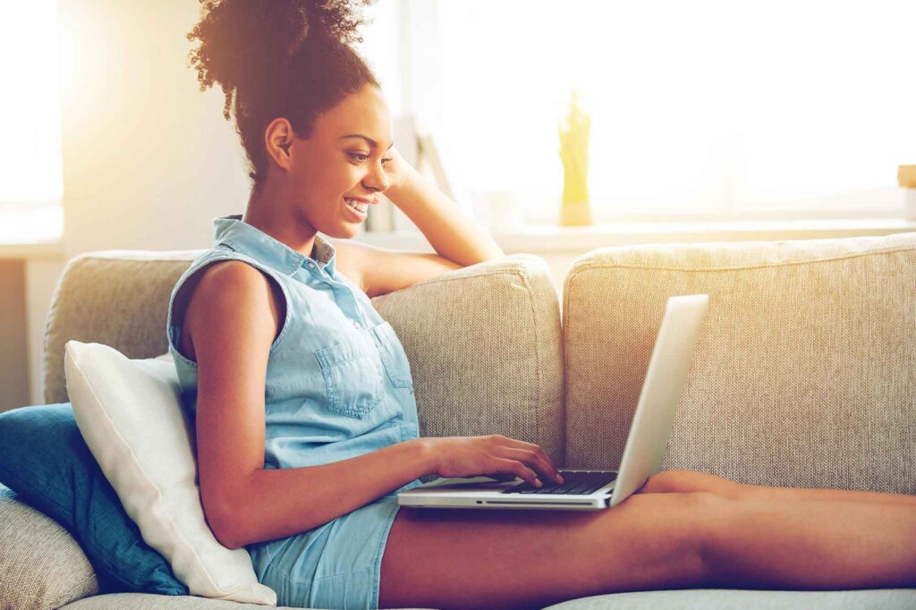 Teen girl on the couch with her laptop