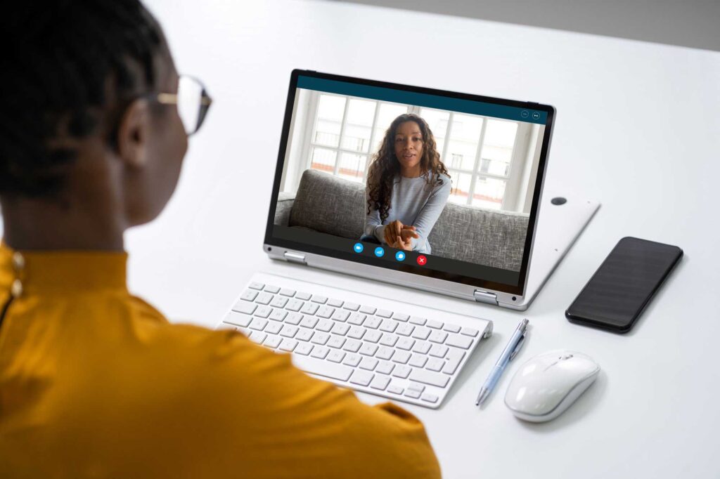 Woman in a telehealth session on her laptop