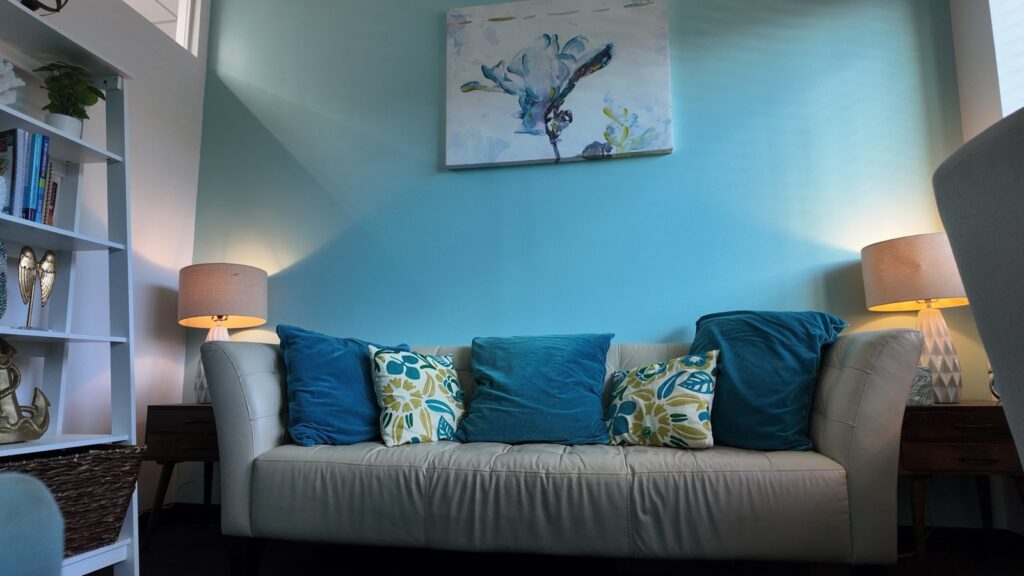 Bright therapy room with blue accents at our Valley Stream office