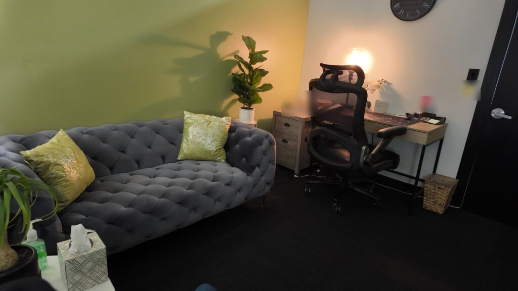 Comfortable therapy room with green accents at Lighthouse Counseling in Valley Stream